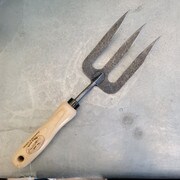 Hand fork garden tool on a table.
